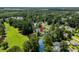 Community aerial view showcasing lush greenery, ponds, and well-maintained homes in a wooded neighborhood at 6576 Pebble Beach Crescent, Myrtle Beach, SC 29588