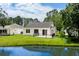 Backyard view featuring a patio with black metal fencing and a tranquil pond at 6576 Pebble Beach Crescent, Myrtle Beach, SC 29588