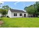 A backyard featuring a black metal fenced-in patio and a well-maintained green lawn at 6576 Pebble Beach Crescent, Myrtle Beach, SC 29588