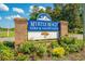Myrtle Beach Golf & Yacht Club entrance sign featuring brick pillars and colorful flower beds at 6576 Pebble Beach Crescent, Myrtle Beach, SC 29588