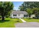 Charming single-story home with white siding, green shutters, and a well-manicured lawn at 6576 Pebble Beach Crescent, Myrtle Beach, SC 29588