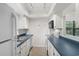 Functional kitchen with white cabinets, contrasting countertops, and modern appliances at 6576 Pebble Beach Crescent, Myrtle Beach, SC 29588