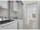 Convenient laundry room with new washer and dryer and white overhead cabinets at 6576 Pebble Beach Crescent, Myrtle Beach, SC 29588