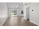 Spacious living room featuring wood floors, a ceiling fan, and sliding glass doors to the patio at 6576 Pebble Beach Crescent, Myrtle Beach, SC 29588