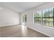 Bright living room with wood floors, sliding glass doors, and view of the lake at 6576 Pebble Beach Crescent, Myrtle Beach, SC 29588