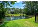 Scenic pond view surrounded by lush landscaping and mature trees in a tranquil community setting at 6576 Pebble Beach Crescent, Myrtle Beach, SC 29588