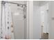 Updated white shower with chrome hardware and floral shower curtain at 6576 Pebble Beach Crescent, Myrtle Beach, SC 29588