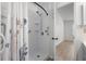 Updated white shower with floral curtain and grab bars for safety and accessibility at 6576 Pebble Beach Crescent, Myrtle Beach, SC 29588