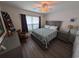 Cozy bedroom with natural light, ceiling fan, and wood-look flooring, offering a comfortable retreat at 671 American Beech St., Loris, SC 29569