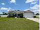 Charming single-story home with a well-manicured lawn and attached two car garage at 671 American Beech St., Loris, SC 29569