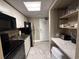 Efficient kitchenette with granite counters, appliances, and handy shelving at 6900 N Ocean Blvd. # 201, Myrtle Beach, SC 29572