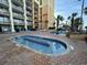 Resort-style pool area with a hot tub, lounge chairs, and access to nearby condos at 6900 N Ocean Blvd. # 201, Myrtle Beach, SC 29572