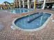 Outdoor pool area features a hot tub, lounge chairs, and a playground at 6900 N Ocean Blvd. # 201, Myrtle Beach, SC 29572