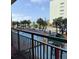 Outdoor pool with palm trees and lounge chairs overlooking the ocean and a splash park at 6900 N Ocean Blvd. # 201, Myrtle Beach, SC 29572