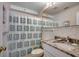 Well-lit bathroom featuring a vanity with a decorative seashell shower curtain at 720 N Waccamaw Dr. # 205, Garden City Beach, SC 29576