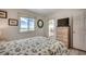 Cozy bedroom with dresser and balcony access overlooking the beach at 720 N Waccamaw Dr. # 205, Garden City Beach, SC 29576