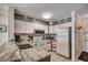 Well-lit kitchen featuring white cabinets, appliances, and marbled countertops, perfect for cooking enthusiasts at 720 N Waccamaw Dr. # 205, Garden City Beach, SC 29576