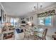 Cozy living room featuring a glass dining table with chairs and stunning ocean views from the balcony at 720 N Waccamaw Dr. # 205, Garden City Beach, SC 29576