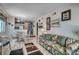 Charming living room with tropical patterned sofa and easy access to a full kitchen and dining area at 720 N Waccamaw Dr. # 205, Garden City Beach, SC 29576