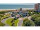 Beautiful clubhouse near the beach, featuring lush landscaping, and a circular driveway at 7374 Sarteano Dr., Myrtle Beach, SC 29572