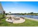 Outdoor fire pit area with waterfront views, perfect for relaxing and entertaining friends at 7374 Sarteano Dr., Myrtle Beach, SC 29572