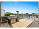 Back patio featuring a built-in grill, Adirondack chairs and a view to the lake at 7374 Sarteano Dr., Myrtle Beach, SC 29572