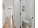 Clean half-bathroom with wood flooring and clean white fixtures near entryway at 775 Plantation Dr. # 53, Little River, SC 29566