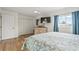 Bedroom with a large closet, natural light, a ceiling fan, and light colored wood flooring at 775 Plantation Dr. # 53, Little River, SC 29566
