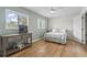 Bedroom with light colored wood flooring, windows that provide lots of natural light, and cool toned walls at 775 Plantation Dr. # 53, Little River, SC 29566