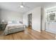 Bright bedroom with a queen bed, ceiling fan, and access to an ensuite bathroom and the stairway at 775 Plantation Dr. # 53, Little River, SC 29566