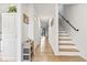 Bright hallway with hardwood floors, white walls, and a staircase leading to the upper level at 775 Plantation Dr. # 53, Little River, SC 29566