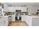 Modern kitchen with white cabinets, stainless steel appliances, and a stylish backsplash at 775 Plantation Dr. # 53, Little River, SC 29566