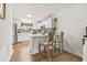 Bright eat-in kitchen with stainless steel appliances, bar-style seating, and wood floors at 775 Plantation Dr. # 53, Little River, SC 29566