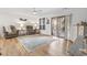 Bright living room with hardwood floors, ceiling fan, comfortable seating and sliding glass door to outdoor space at 775 Plantation Dr. # 53, Little River, SC 29566