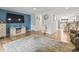Open living room with hardwood floors, modern TV, and seamless flow into the kitchen area at 775 Plantation Dr. # 53, Little River, SC 29566