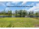 The expansive fenced backyard features a serene pond view, enhancing privacy at 788 Dusty Pine Way, Myrtle Beach, SC 29588