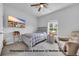 Cozy bedroom with a blue-and-white bedspread, a ceiling fan, and a window at 788 Dusty Pine Way, Myrtle Beach, SC 29588