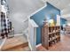 Warm entryway featuring a staircase, wooden floors, and a blue accent wall with decorative shelving at 788 Dusty Pine Way, Myrtle Beach, SC 29588