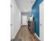 Hallway featuring wood floors and a shoe organizer against a blue accent wall at 788 Dusty Pine Way, Myrtle Beach, SC 29588