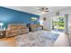 Spacious living room featuring reclining sofas, wood floors, a ceiling fan, and backyard access at 788 Dusty Pine Way, Myrtle Beach, SC 29588