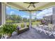 Relaxing screened porch offers a peaceful outdoor living space overlooking a beautiful garden and serene lake at 788 Dusty Pine Way, Myrtle Beach, SC 29588