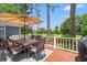Spacious wooden back deck with an outdoor dining set overlooking a golf course at 890 Knoll Dr., Little River, SC 29566