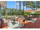 Spacious wooden back deck with an outdoor dining set and lounge seating at 890 Knoll Dr., Little River, SC 29566