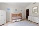 Bright Bedroom with vaulted ceiling, wood crib, white furniture and laminate flooring at 890 Knoll Dr., Little River, SC 29566