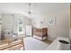 Bright Bedroom with vaulted ceiling, wood crib, white furniture and a ceiling fan at 890 Knoll Dr., Little River, SC 29566