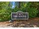 Community sign for 'The Knoll' with dark wood and decorative lighting at 890 Knoll Dr., Little River, SC 29566