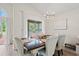 Dining room showcasing a sliding glass door to the screened porch with chandelier at 890 Knoll Dr., Little River, SC 29566