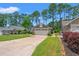 Charming home featuring a two-car garage, manicured lawn and low foundation shrubbery at 890 Knoll Dr., Little River, SC 29566