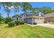 Charming home featuring a two-car garage, manicured lawn and low foundation shrubbery at 890 Knoll Dr., Little River, SC 29566