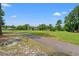 Paved path through grass toward homes and fairway on the golf course at 890 Knoll Dr., Little River, SC 29566